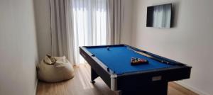 a blue pool table in a room with at The Frenchie's House in Rabo de Peixe