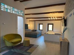 a living room with a bed and a couch and a table at Il Cuore d'Abruzzo in Introdacqua