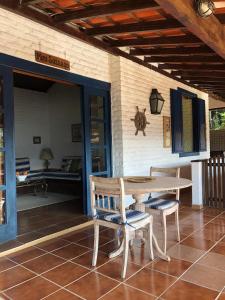 a wooden table and chairs on a patio at Paraiso de Angra in Angra dos Reis