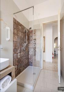 a glass shower in a bathroom with a sink at Dolce Sicily a 1km dal centro in Palermo