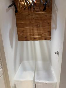 a bathroom with white counters and a wooden ceiling at Studio Apartment with Garden Jersey City in Jersey City