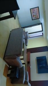 a living room with a chair and a desk at Vickie's Home in Lagos