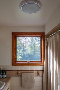 a bathroom with a window and a sink and a sink at Dreamwood in Jeffersonville +67 photos