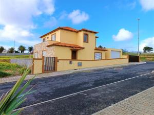 a yellow house on the side of a road at La Maison Dorée in Porto Santo