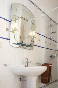 a bathroom with a sink and a mirror at Casa do Poço in Faro +17 photos