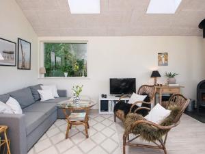 a living room with a couch and a table at Secluded Haven in Kelstrup - By Traum Ferienwohnungen in Kelstrup Strand