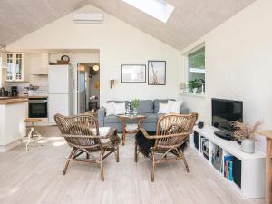 a living room with two chairs and a couch at Secluded Haven in Kelstrup - By Traum Ferienwohnungen in Kelstrup Strand +23 photos