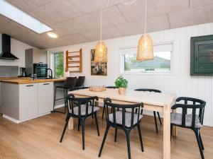 a kitchen and dining room with a table and chairs at 6 person holiday home in Rønde-By Traum in Rønde