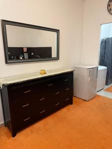 a bathroom with a dresser with a mirror on the wall at Abdallah Wa'el Adham in Aqaba +29 photos