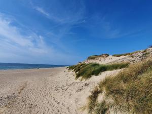 a sandy beach with the ocean in the background at 6 person holiday home in Ulfborg-By Traum in Ulfborg