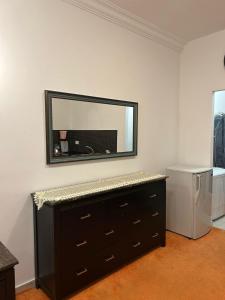 a room with a dresser and a mirror on the wall at Abdallah Wa'el Adham in Aqaba