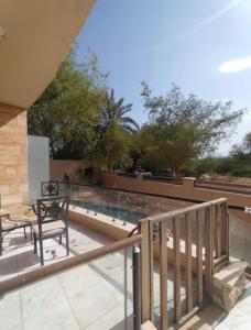 a balcony with a view of a swimming pool at Abdallah Wa'el Adham in Aqaba