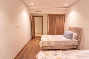 a room with two beds and a chair in it at Modern apartment with pool view Tamaris in Tamaris