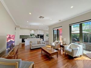 a living room with a couch and a table at Classic Meets Modern in Central Wagga in Wagga Wagga