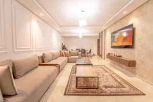 a living room with a couch and a table at Modern apartment with pool view Tamaris in Tamaris