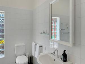a white bathroom with a toilet and a sink at Classic Meets Modern in Central Wagga in Wagga Wagga +24 photos