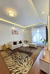 a living room with a couch and a table at Noah Luxury Airport Drive Gated Apartment in Addis Ababa +18 photos