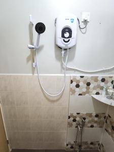 a bathroom with a shower with a camera on the wall at De Suria Homestay Jitra in Jitra +48 photos