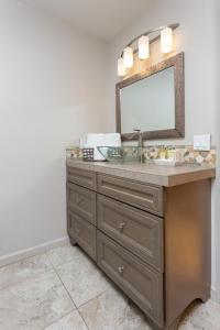 a bathroom with a sink and a mirror on a dresser at Serendipity Retreat - Dogs Welcome Farm Tours and Private Yoga Sessions in Atascadero