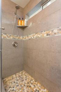 a bathroom with a shower with a glass door at Serendipity Retreat - Dogs Welcome Farm Tours and Private Yoga Sessions in Atascadero +17 photos