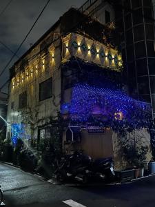 a building with blue christmas lights on it at 東京吉久花園旅舘 in Tokyo +12 photos