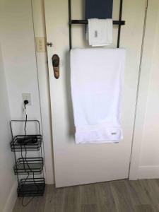 a white towel is hanging on a wall at The yellow house in Lower Barrington