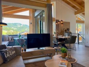 a living room with a large flat screen tv at Almchalet Alpenglück in Sankt Lambrecht