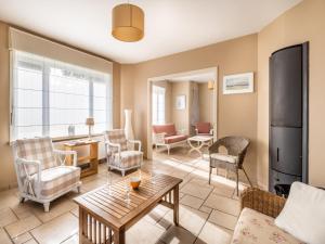 a living room with a couch and a table at LAuthentique in Sint-Idesbald +18 photos
