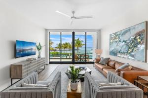a living room with a couch and chairs at Harbor Island Beach Club 205 in Melbourne Beach