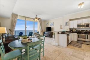 een keuken en woonkamer met een tafel en stoelen bij Ocean Front Condo 29th Floor - Must be 25 to Book in Panama City Beach