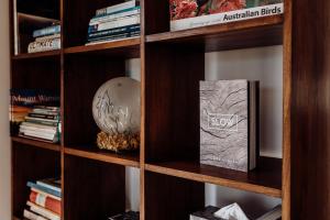 a book shelf with a book and a globe on it at Doric Dreams - Short Stroll to St Helens in St Helens