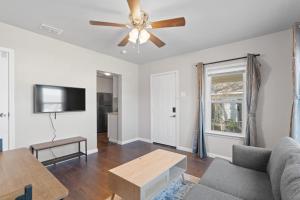 a living room with a couch and a ceiling fan at Charming 1-Bedroom Retreat in Fort Worth in Fort Worth