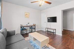 a living room with a couch and a table at Charming 1-Bedroom Retreat in Fort Worth in Fort Worth