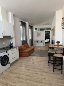 a kitchen and living room with a couch and a table at Bouzasol in Vigo