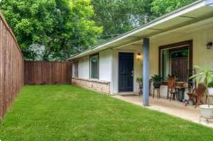 a backyard with a fence and a grass yard at 2bd 1bth Newly Renovated Home near Cowboys Stadium etc in Arlington