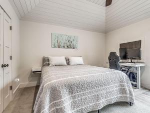 a white bedroom with a bed and a desk at Cozy 1-Bedroom Retreat in Tulsa in Tulsa