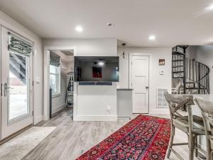 a kitchen with white cabinets and a red rug at Cozy 1-Bedroom Retreat in Tulsa in Tulsa