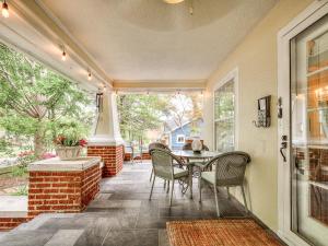 a screened in porch with a table and chairs at Stylish 3-Bedroom Home in Tulsa in Tulsa