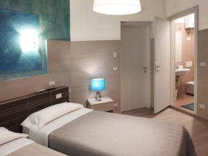 Postel nebo postele na pokoji v ubytování Albergo Annabella