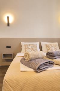 a bedroom with two beds with pillows and blankets at 4 Lemons Luxury Studios in Ammouliani +79 photos