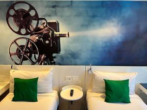 a room with a bed with a camera on the wall at ibis Styles Montevideo Biarritz in Montevideo +95 photos
