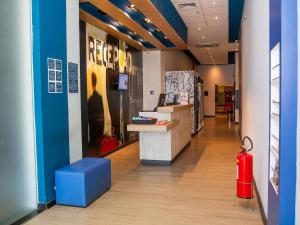 a lobby of a store with a red fire hydrant at ibis budget Itaperuna in Itaperuna