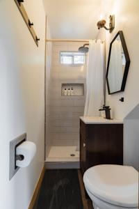 a bathroom with a toilet and a shower at Hidden Pines Cabin - Nearby Snow & Play in Big Bear City Airport +24 photos