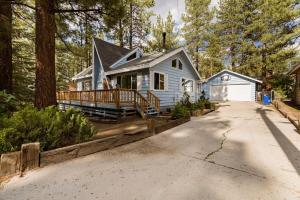 a blue house with a porch and a driveway at Hidden Pines Cabin - Nearby Snow & Play in Big Bear City Airport