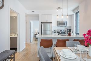 a kitchen and dining room with a table and chairs at Corner 2BR Old Port - Free Indoor Parking in Montreal +36 photos