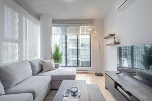 a living room with a couch and a table at Corner 2BR Old Port - Free Indoor Parking in Montreal