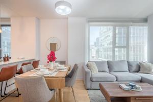 a living room with a table and a couch at Corner 2BR Old Port - Free Indoor Parking in Montreal