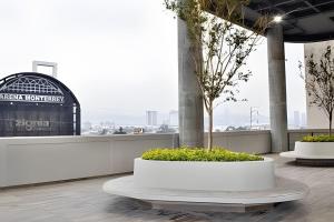 een gebouw met twee witte potten met planten op het dak bij Incredible 2Br Apt BBQ Arena Mty in Monterrey