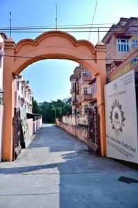 a bridge over a street with buildings in the background at Prakriti wellness stay in Haridwār