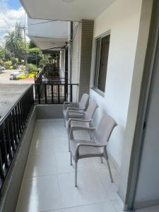a row of chairs sitting on a balcony at Full apartment near El Poblado in Medellín +5 photos